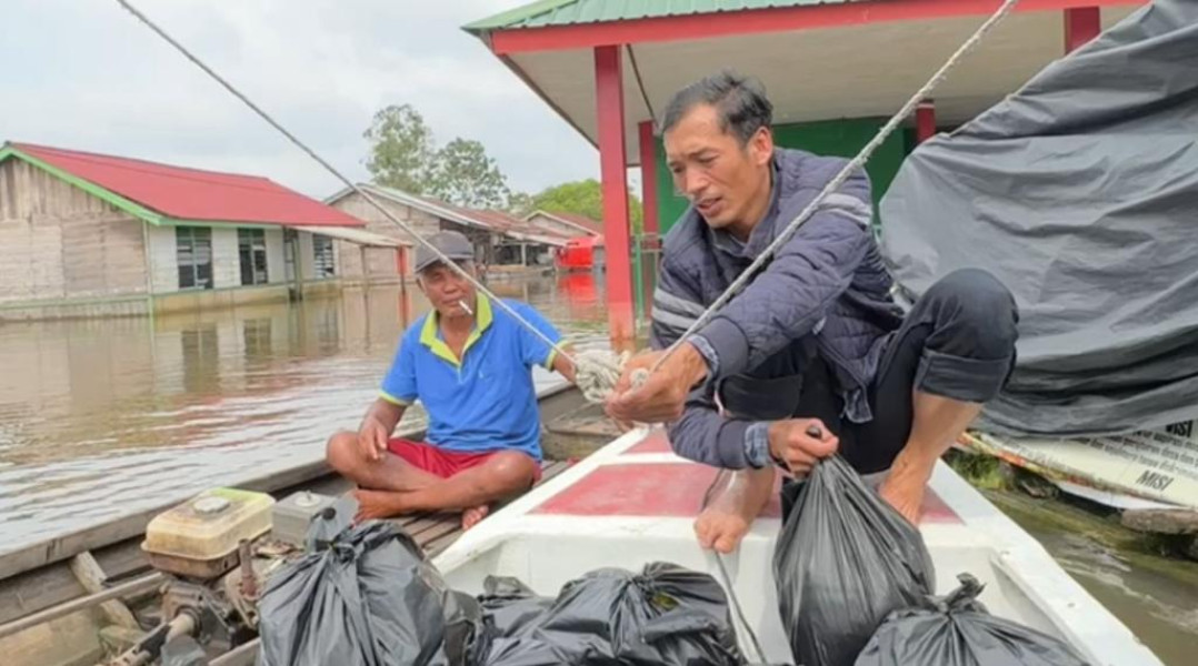 Peduli Korban Banjir, Notaris Ragil Gunakan Kucai Bagikan Bantuan Sembako di Desa Kuala Terusan